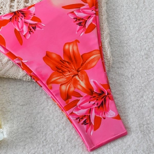 Detailed macro view of pink lily floral pattern on high-quality elastic bikini fabric