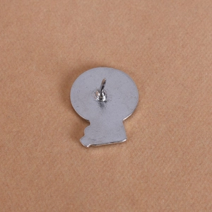 Detail view of the silver alloy badge back featuring a secure metal pin fastener