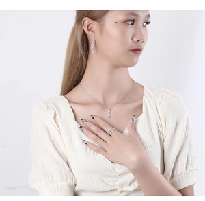 Elegant silver leaf jewelry set with micro-pave crystals on model showing necklace and ring