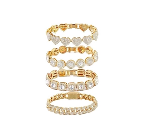 Detailed set of four gold hip hop bracelets featuring heart, round, and square crystal designs