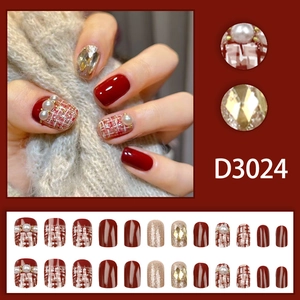 Champagne pearl press-on nails with red tweed pattern and sparkling rhinestones