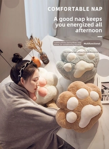 Detailed view of plush cat paw pillow with a gray flannel blanket for office naps