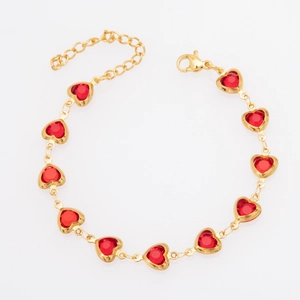 Close-up of gold-plated bracelet featuring red heart glass stones and lobster clasp