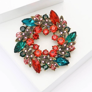Elegant vintage gold floral wreath brooch with vibrant red and teal teardrop gemstones