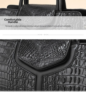 Close-up of black crocodile pattern handbag showing precise stitching and durable handle