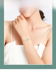 Close-up of S925 silver bracelet featuring a square green gemstone and fine O-chain link