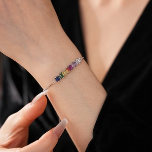 Close-up of adjustable silver bracelet with sparkling rainbow rectangle cubic zirconia