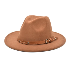 Detailed macro of khaki wool fedora hat crown with leather buckle and metal studs