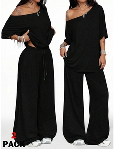 Detalle de un conjunto casual negro de 2 piezas con top corto y pantalones anchos