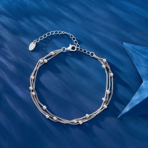 Elegant 925 sterling silver triple-layer bead bracelet with adjustable chain on blue surface