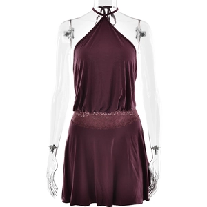 Detail view of the lace patchwork design and waistline on a burgundy halter dress