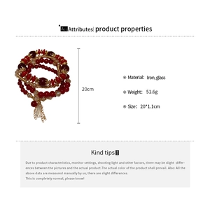 Detail of red glass beaded multi-layer bracelet with iron charms and 20cm length indicator