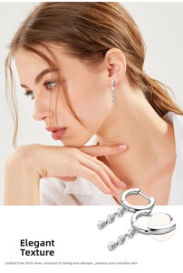 Detail of S925 sterling silver tassel earrings with three vertical zircon stones