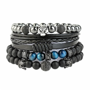 Stack of Tiger Eye beads and woven leather bracelets with leopard and crown charms