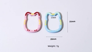 Cat-shaped colorful spring ring keychains with pink and blue polka dots and size markers