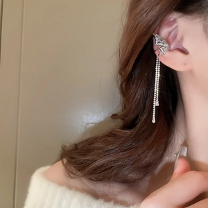 Detail of silver butterfly tassel ear cuff with sparkling zircon fringe on a model ear