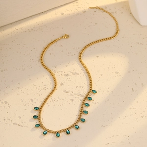 Close-up of gold stainless steel necklace with blue teardrop-shaped zircon tassels