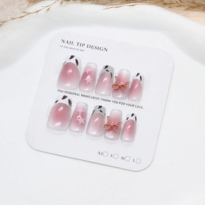 Handmade leopard cat-eye press-on nails with pink 3D bow and star accents in coffin shape