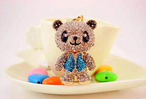 Macro shot of cute panda keychain featuring intricate blue and white rhinestone detailing