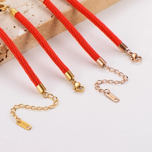 Braided red string lucky bracelet with interlocking roman numeral rings and gold finish