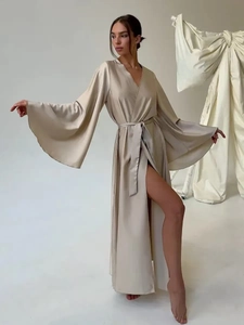 Detail of champagne gold satin robe featuring long split hem and flared sleeves