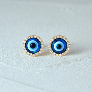 Close-up of S925 sterling silver evil eye stud earrings with blue enamel and crystals