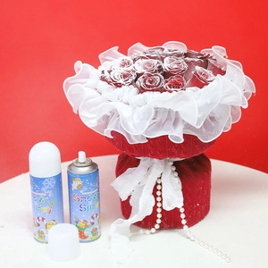 Two 250ml Snow Spray bottles with artificial snow effect on a red rose bouquet