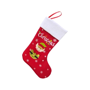Detail of red Christmas stocking with elf embroidery and white faux fur cuff decoration