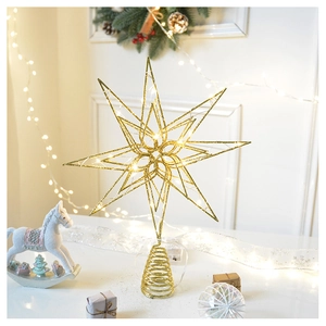 Close-up of golden star tree topper with glitter finish and warm LED light details