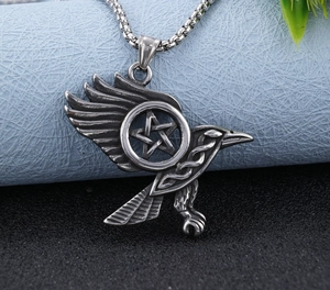 Macro view of eagle pendant with star symbol in vintage silver finish and detailed texture