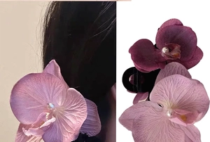 Detail of orchid hair clips with realistic fabric petals and pearl center accents