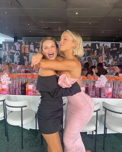 Detailed look at the ruched pink tube dress and elegant black off-shoulder blazer gown