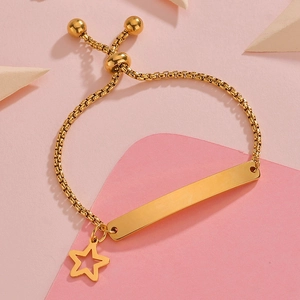 Macro detail of gold curved plaque bracelet with star charm and adjustable box chain