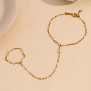 Minimalist 18K gold plated stainless steel pig nose ring bracelet on warm beige background