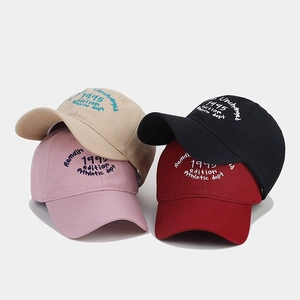 Close-up of cotton baseball caps showing high-quality embroidery and multiple colors