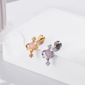 Close-up of heart-shaped planetary stud earrings with pink and purple zircon stones