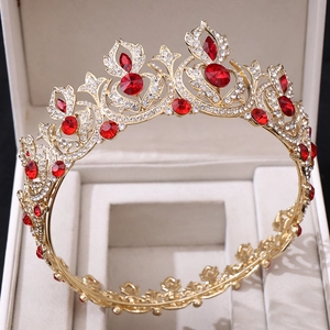 Close-up of vintage gold bridal crown with red gems and crystals in a jewelry box