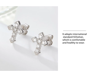 Detailed macro view of S925 sterling silver cross stud earrings with sparkling cubic zirconia