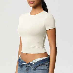 Detailed fit of white short sleeve yoga top with tight crew neck and elastic fabric