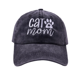 Close-up of white Cat Mom embroidery and cat paw heart on washed black baseball cap