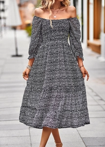 Detail of off-the-shoulder long sleeve dress featuring black and white floral pattern
