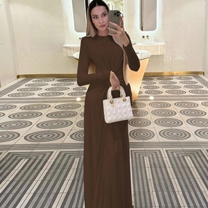 Detail of waist pleats on this slim fit dark brown long sleeve maxi dress
