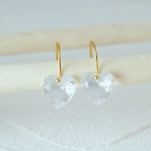 Detailed close-up of S925 silver heart earrings with sparkling crystals and golden hooks
