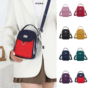 Multi-compartment nylon crossbody bag with earphone port and adjustable shoulder strap