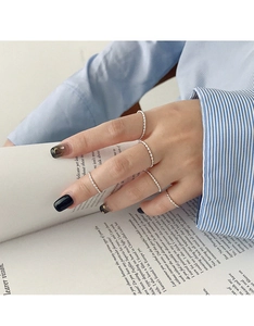 Close-up of minimalist S925 sterling silver twisted rope rings on a model's fingers