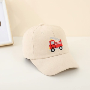Detail of embroidered red fire truck on beige cotton twill baseball cap for kids
