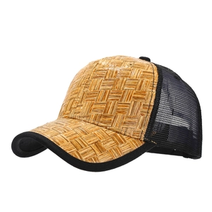 Straw woven trucker hat with brown textured visor and breathable black mesh back