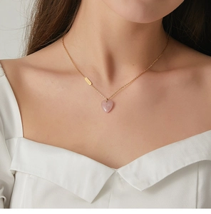 Close-up of pink heart-shaped stone pendant on 18K gold-plated stainless steel chain