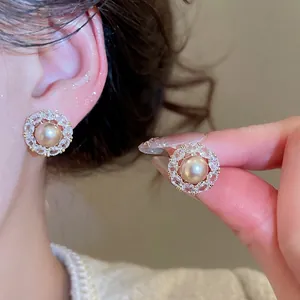Elegant silver needle pearl stud earrings with zircon bow and champagne gold finish