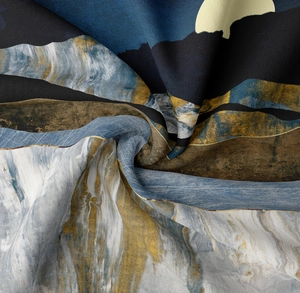 Macro detail of mountain tapestry showing fine fabric texture and artistic draped pleats